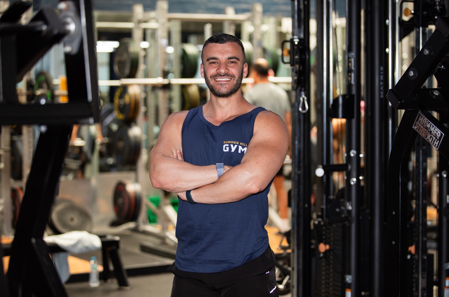 Michael Reaiche smiling with his arms crossed at Summer Hill Gym